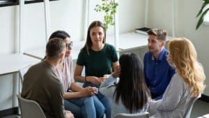 Group of students talking in a room.