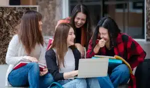 Four female students studying in the stairs of a building.