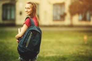 Female student walking in the campus.