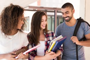 Three students talking while walking.