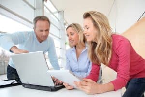 Professor introducing college degrees in us to a woman using a laptop.