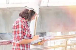 View of a female civil engineer looking at her notes.