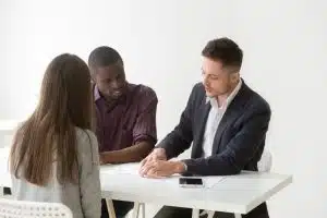 View of a student talking to a person wearing a suit.