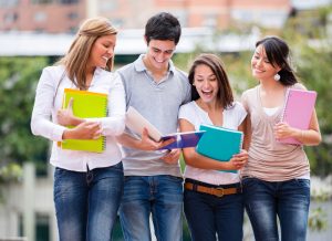 Group of students walking while holding her books.