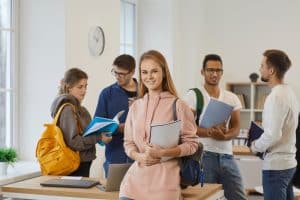 Group of students talking in a classroom.