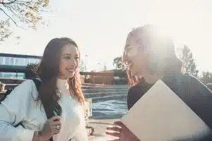 Two female students talking in the campus.