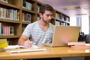 Male student looking at his laptop.