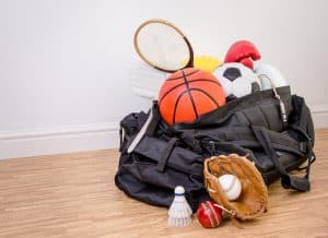Sports equipments placed on a bag.