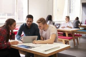 Group of students studying in a room.