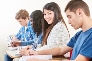 Group of students answering a test in a room.