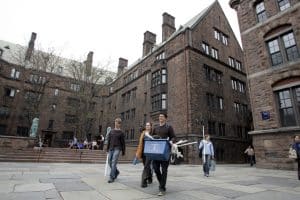Yale students carrying their stuff as they move in to one of the Yale dorm rooms