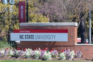 North Carolina State University signage attached to a brick wall