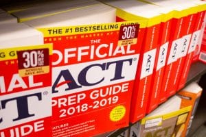 a bunch of ACT prep guide books with red cover