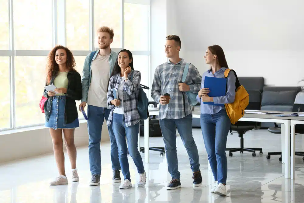 Group of students standing on a room.