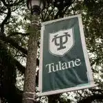 A green banner displaying the Tulane University logo on campus, symbolizing the school’s growing selectivity and the competitive Tulane acceptance rate.
