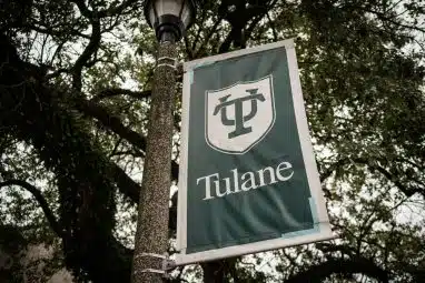 A green banner displaying the Tulane University logo on campus, symbolizing the school’s growing selectivity and the competitive Tulane acceptance rate.
