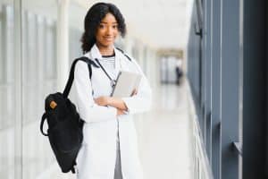 View of a female medical student standing in the middle of a building.