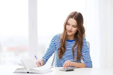 A student writing notes while studying, representing the analytical thinking and philosophical reasoning skills encouraged by the John Locke Essay Competition.