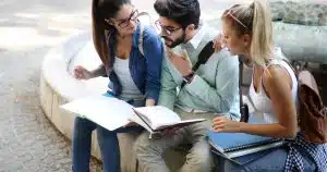 three students studying outside