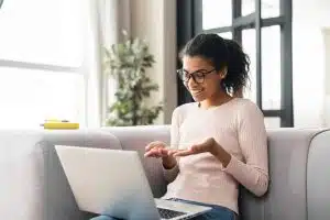 View of a woman using a laptop while studying.