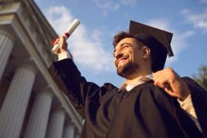 A student who just finished a phd program wearing a graduation gown