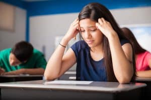 A female student looking problematic while taking a test