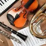 A set of musical instruments with music sheets in the middle