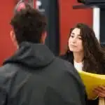 a young woman interviewing a male athelete