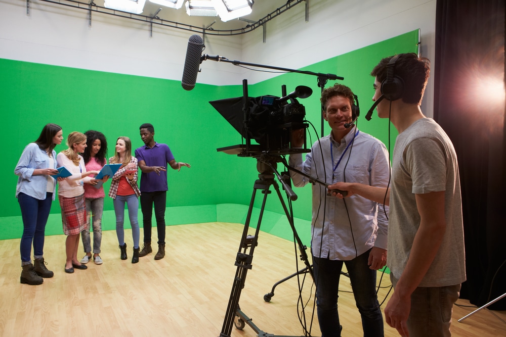 a group of students working with a cameraman