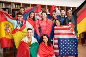 a group of international students, each holding the flag of their origin country