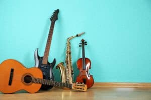 musical instruments laid against a sky blue wall