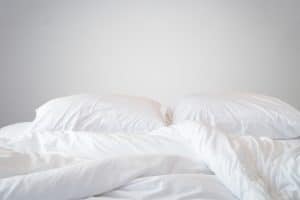 White sheets and pillows covered in white pillow case