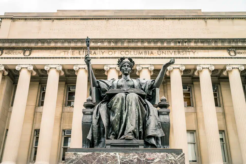 front building of Columbia University with female statue at the very center