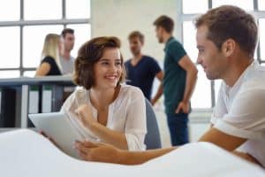 Two business students talking on table.