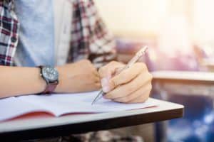 View of an unidentified person answering an exam.