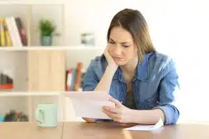 a woman sitting and reading a letter