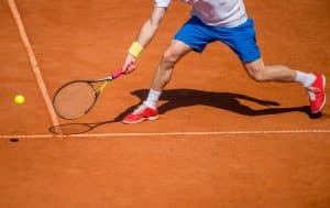 unidentified male tennis player playing in the court