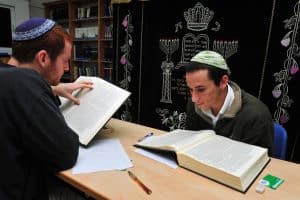 two Judaism scholars facing one another