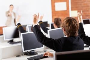 boarding school students inside a class participating in the class discuss