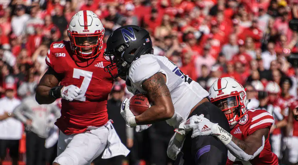 A Northwestern football player against a player from a rival team