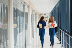 two college students walking in a corridor
