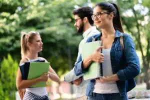 Three students walking in the campus.