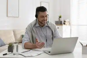 a male intern talking to someone via his laptop