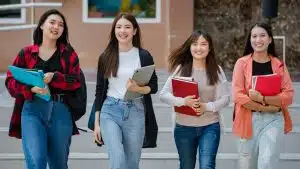 Group of students walking in the campus.