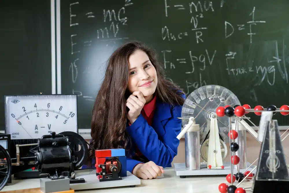 Physics major student surrounded by physics-related items
