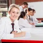 Female student writing in the classroom.