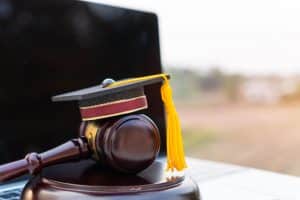 A graduation hat resting on top of a gavel