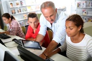 a teacher demonstrating something on the computer