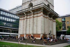 Students hanging out of in the Imperial College London tower.