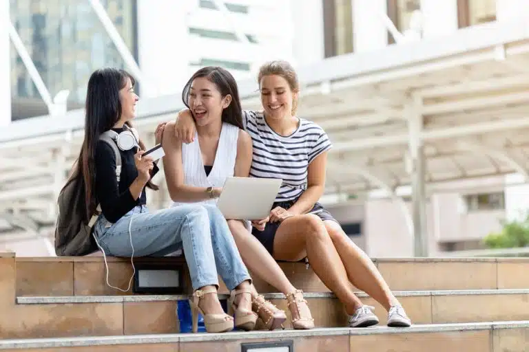 three female students in a staircase